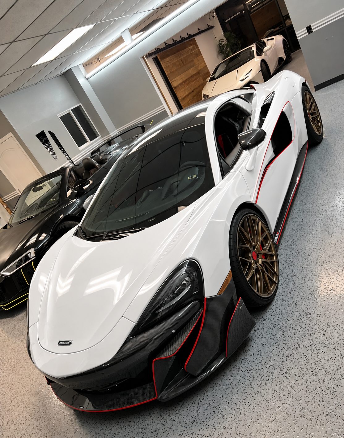 White McLaren 570S before its custom black and white livery wrap