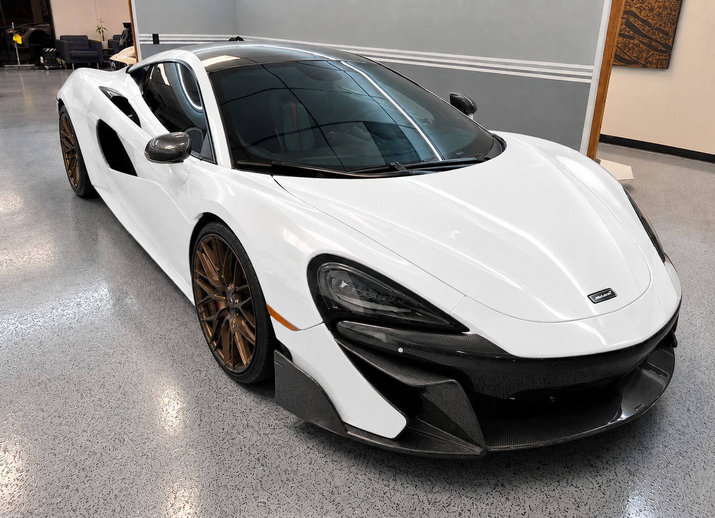 White McLaren 570S before its custom livery wrap, front three-quarter view
