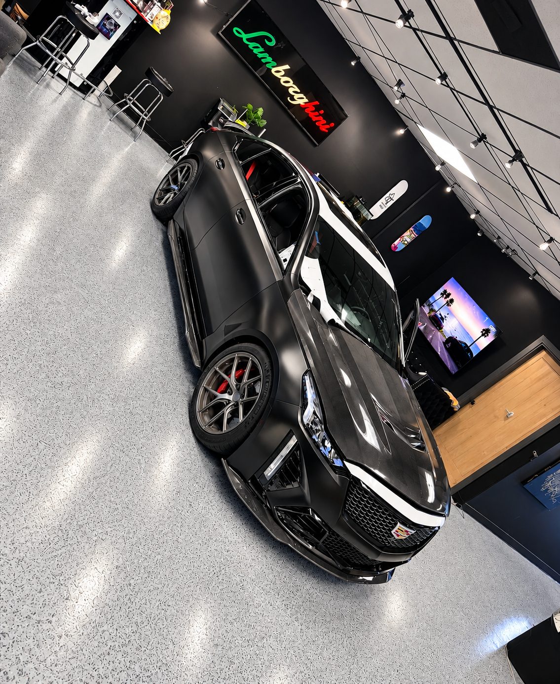 Cadillac CT5-V Blackwing after a full satin black vinyl wrap, same angle as the before photo