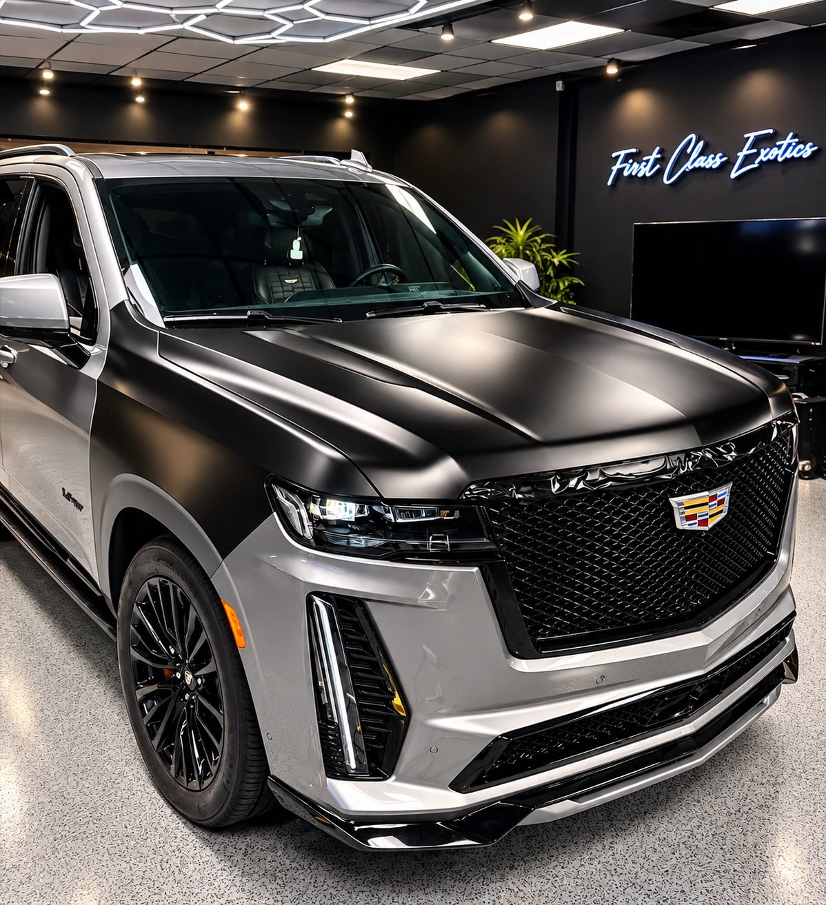 Cadillac Escalade mid-wrap, transitioning from factory silver to satin black