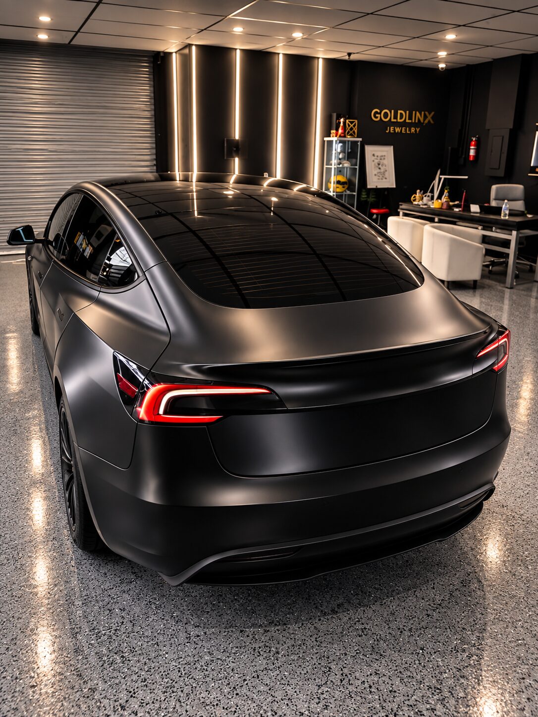 Rear view of a satin black wrapped Tesla Model 3 with 4-stage ceramic coating