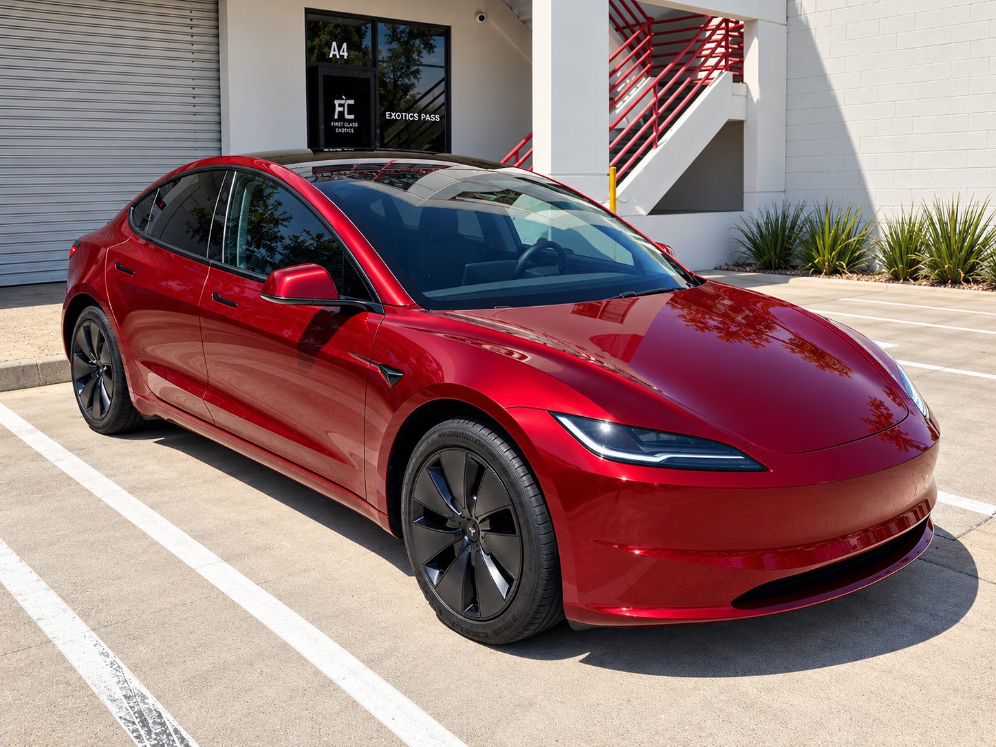 Red Tesla Model 3 before its satin black vinyl wrap, outside our Costa Mesa shop